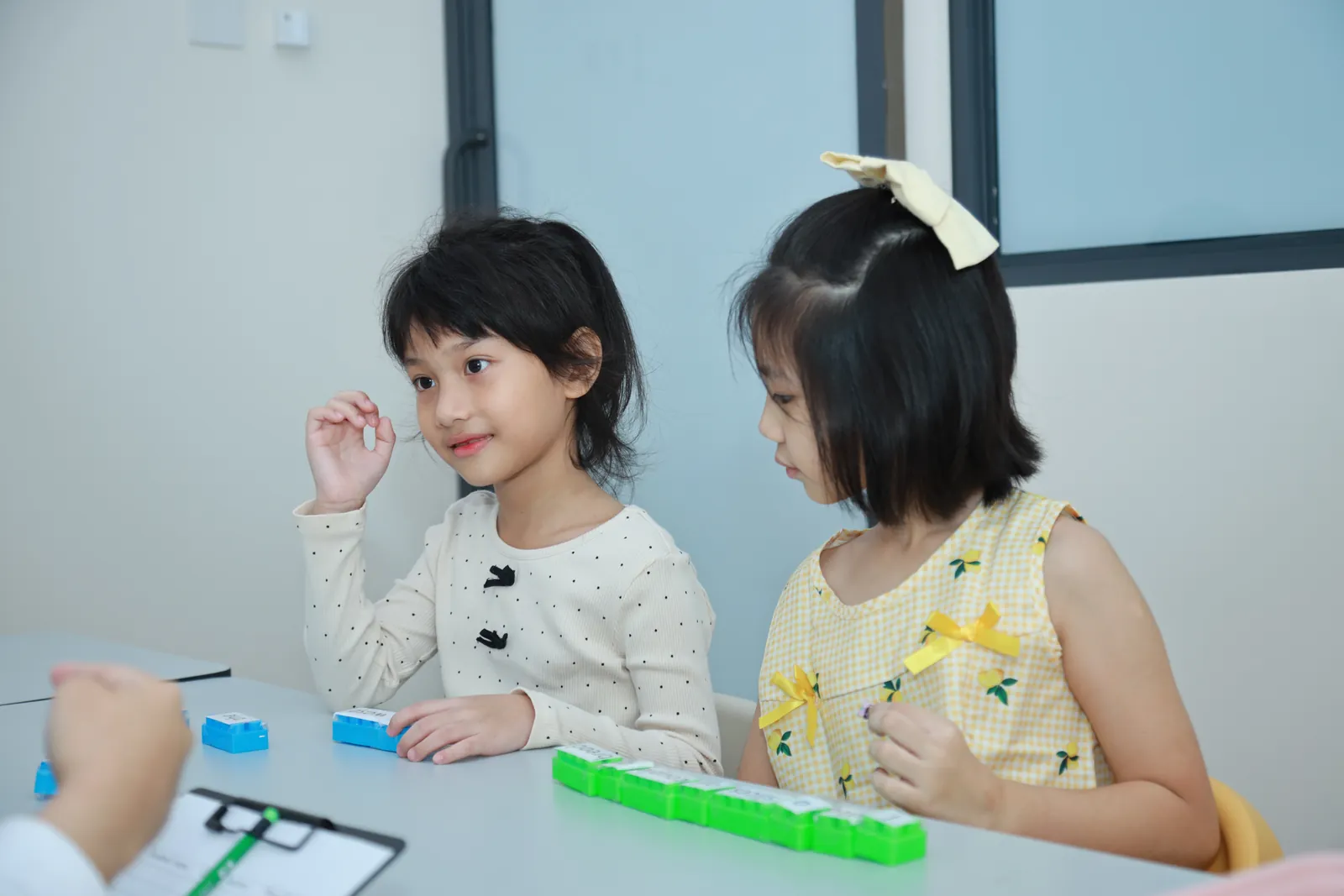 Two children working with phonics materials